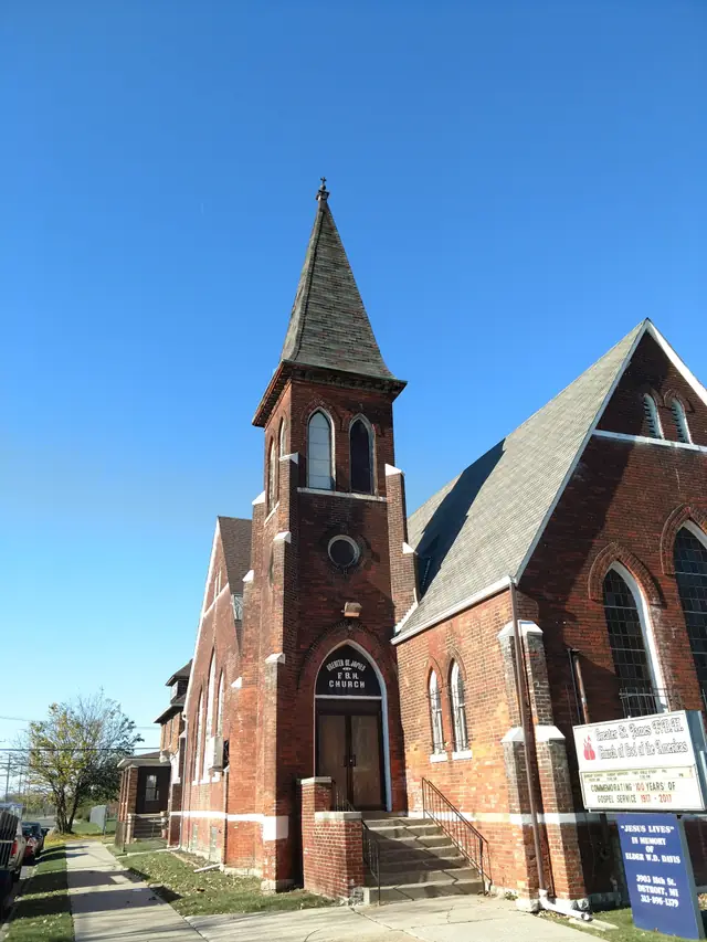 Red-brick church exterior under its steep roof
